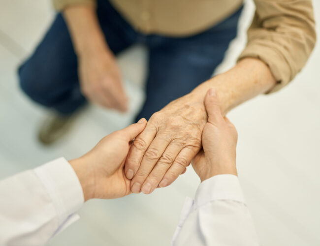 Cropped photo of a medical doctor checking hand function of a senior patient